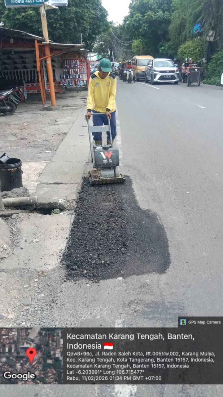 Petugas Dinas PUPR Kota Tangerang sedang melakukan penambalan jalan berlubang menggunakan material cold mix di Jalan Raden Saleh Karang Tengah.